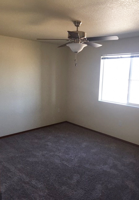 Image of carpet room  with fan and window
